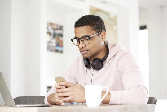 Young man text messaging