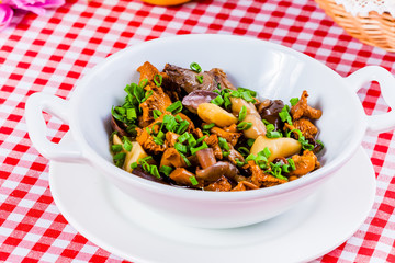 Marinated mushrooms in white bowl