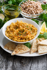 Arabic sauce hummus with flatbread, vertical