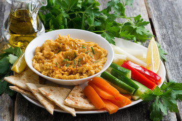 Arabic sauce hummus with flatbread and fresh vegetables