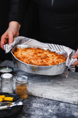 Chef served hot stuffing with mushrooms and beef minced meat in casserole