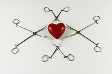 Medical surgical Instruments and heart on white background.