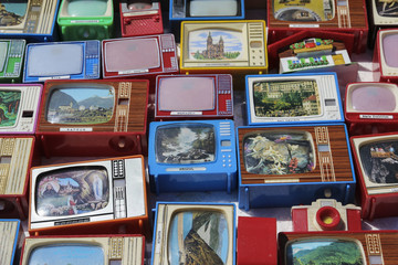 Collection of souvenir click TVs on a flea market