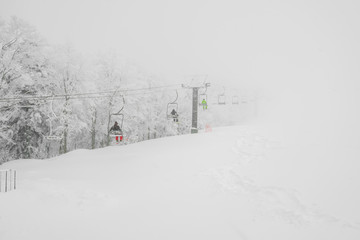 Ski lift over snow mountain in ski resort .