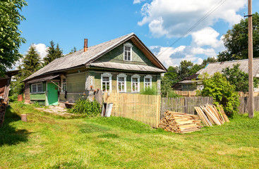 Fototapeta na wymiar Old rural wooden house in russian village in summer sunny day