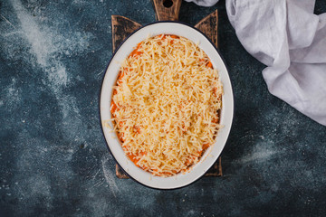 Baked sweet potatoes pie crust with cheese, pecans and maple syrup on a baking tray