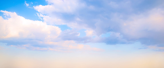 Sky background. Nature composition. Panoramic sunset sky background. Bright blue sky with lighted clouds. 