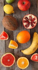 Fresh fruits. Mixed fruits background. Healthy eating, dieting. Background of healthy fresh fruits. Fruit salad - diet, healthy breakfast. pomegranate, persimmon, tangerine, banana, lemon 