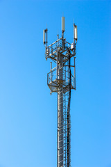 Cell phone tower on blue sky background