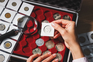 Box with collectible coins and magnifying glass