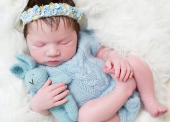 Serene baby dressed in blue costume, closeup