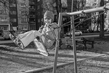Little girl on swing at playground 