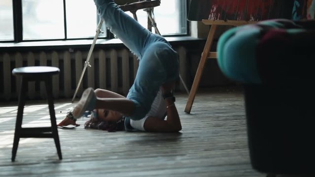 irl artist with makeup dancing on the floor. Stylish art workshop.
