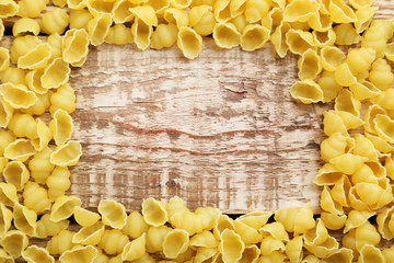 Pasta penne on the brown wooden table