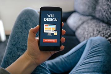 Girl holding smart phone with web design concept on screen. All screen content is designed by me