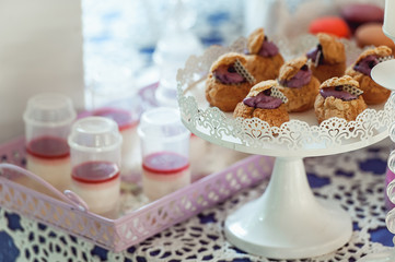 Eclairs with blueberry filling On White Stand.
