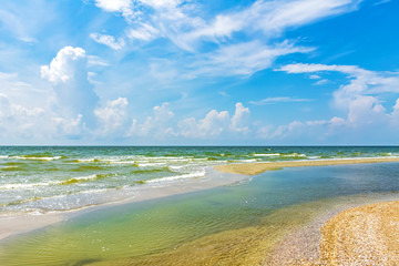 Beach on a sunny day, blue sky and azure water
