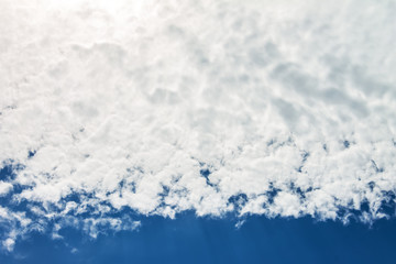 Sun shines through the clouds and the blue sky. Nature background.