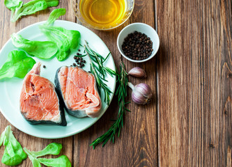 Fresh fish and vegetables on a wooden table. Preparation of dishes from seafood. Banner for the restaurant. Close-up.