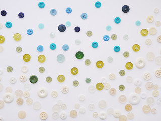Background of multi-colored buttons. Abstract background. Pattern of buttons on a white background.
