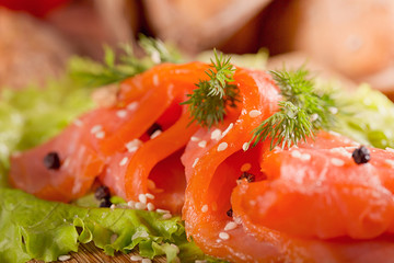 Slices of smoked salmon with dill, chile pepper, tomatoes and bread