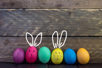 Colorful funny easter egg on wooden table . Happy Easter