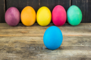 Fototapeta na wymiar Colorful handmade easter eggs on a wooden table