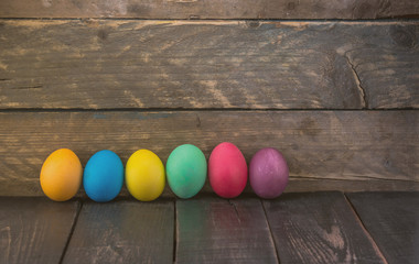 Colorful handmade easter eggs on wooden desk