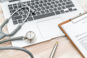 Stethoscope and prescription on laptop