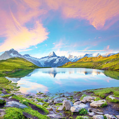 Fantastic landscape at sunrise over the lake in the Swiss Alps, Europe. Wetterhorn, Schreckhorn,...