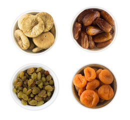 Collage of different dried fruits. Raisins, dates, dried apricots, figs isolated on white background. Top view.