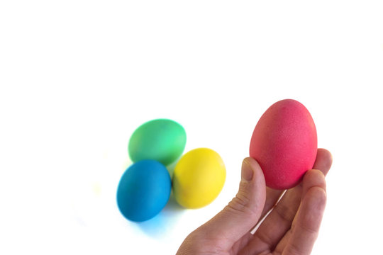 Hand with colorful easter egg on a white background