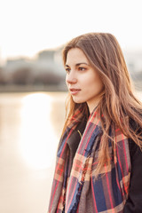 Young attractive girl in the city at sunset