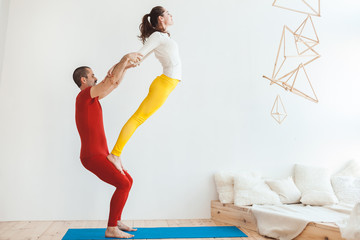 Yoga exercises in the morning for a couple at home.