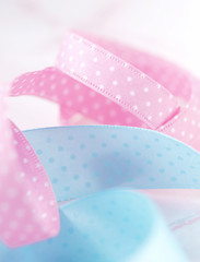 Pink and blue dotted ribbons on light marble background