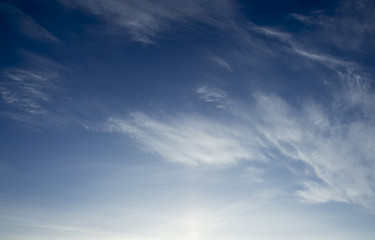 gray sky with few fluffy clouds