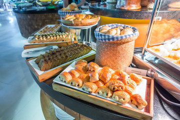 Assortment of fresh pastry on table in buffet .