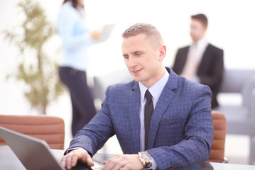 Young businessman working with laptop at office