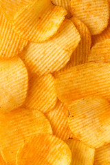 background corrugated delicious golden chips with texture close-up macro and sunlight