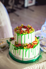 green style wedding cake with fruits on top