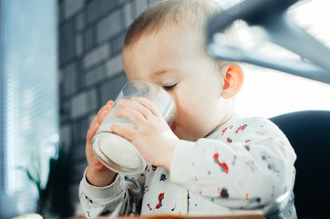 Beautiful little boy drinking milk