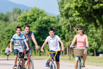 Fototapeta premium Family of four on bike tour in summer