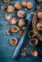 Walnut in wicker basket on blue old wooden board rustic style