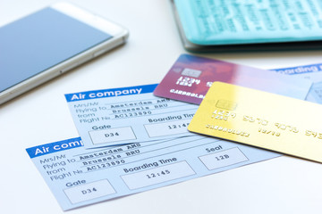 travel concept with credit cards and flight tickets on wooden table