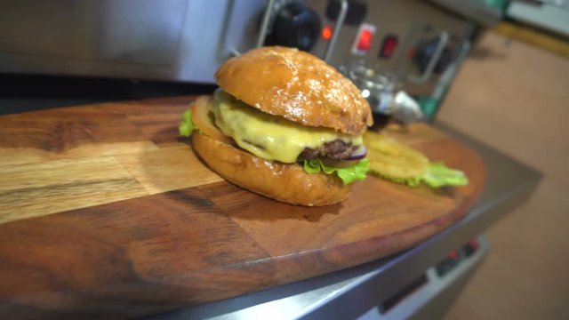 Tasty burger with cheese, lettuce, onion, tomatoes and pineapple.