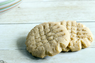 Homemade peanut butter cookies on light wood background