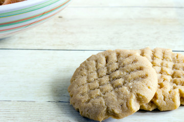 Homemade peanut butter cookies on light wood background