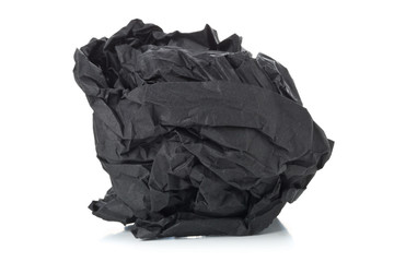 Crumbled black paper ball on white background