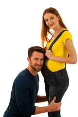 Fototapeta premium happy couple - man listening to pregnant woman belly