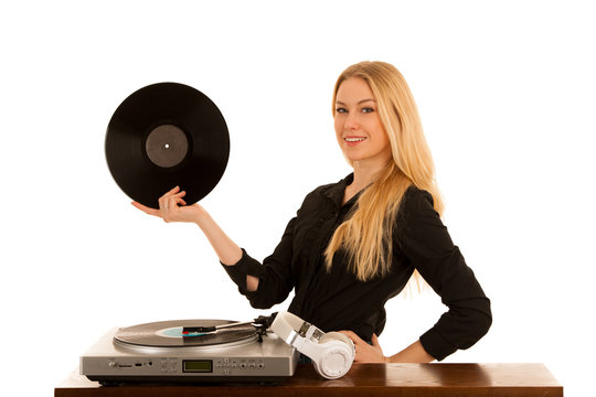 Woman listening music on gramophone with vinyl in her hands isolated over white